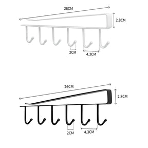 Imagem mostrando as dimensões do Suporte de Metal para Xícaras nas cores branco e preto. 26 centímetros de comprimento e 2.8 centímetros de altura. 